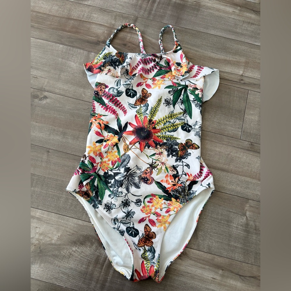 Next one-piece swimsuit for girls (age 11) with cross-back straps.